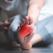 person holding their foot in pain