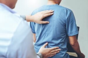 closeup of chiropractor hands on a patient’s back