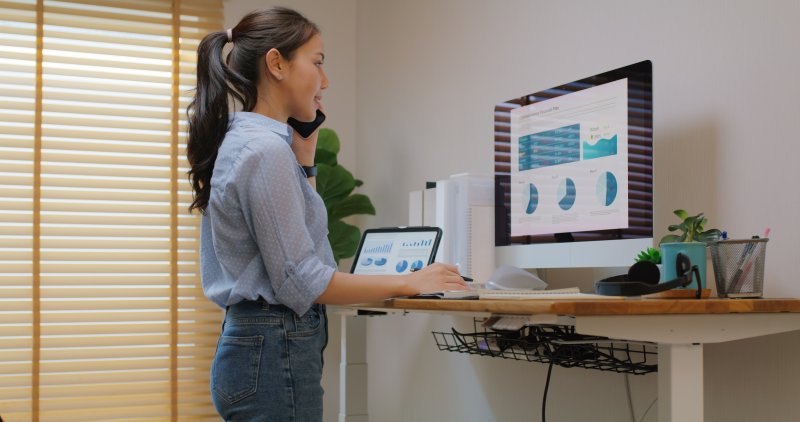 woman standing at her desk with good posture