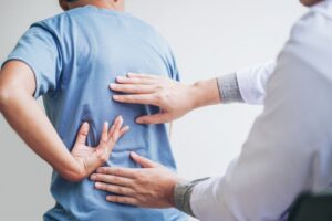 patient talking to a chiropractor about his back pain